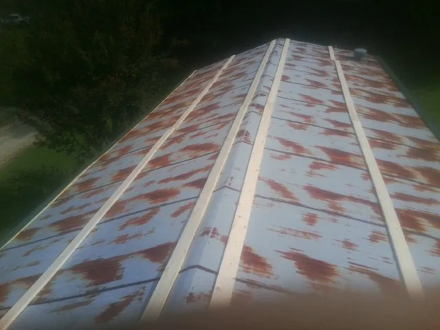 Rusted metal roof panels with new wood purlins before replacement — Storm Damage Roof Repair in Berlin by Roofing Brothers